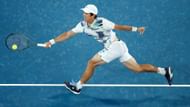 Mackenzie McDonald retrieves a ball at the 2023 Australian Open